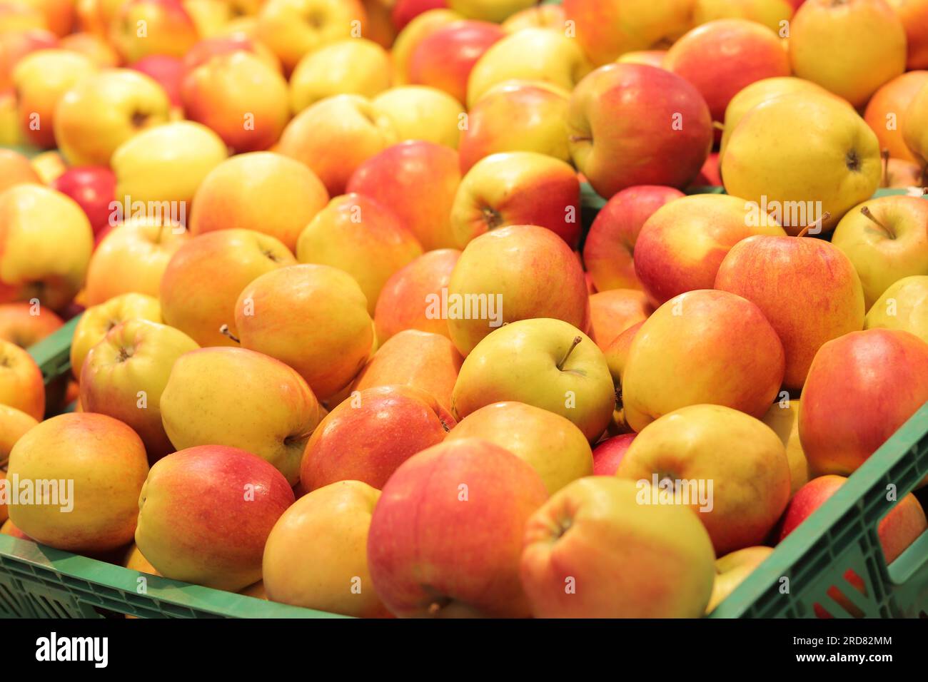 Apples in plastic boxes in a store, closeup. Ripe apples on sale, side