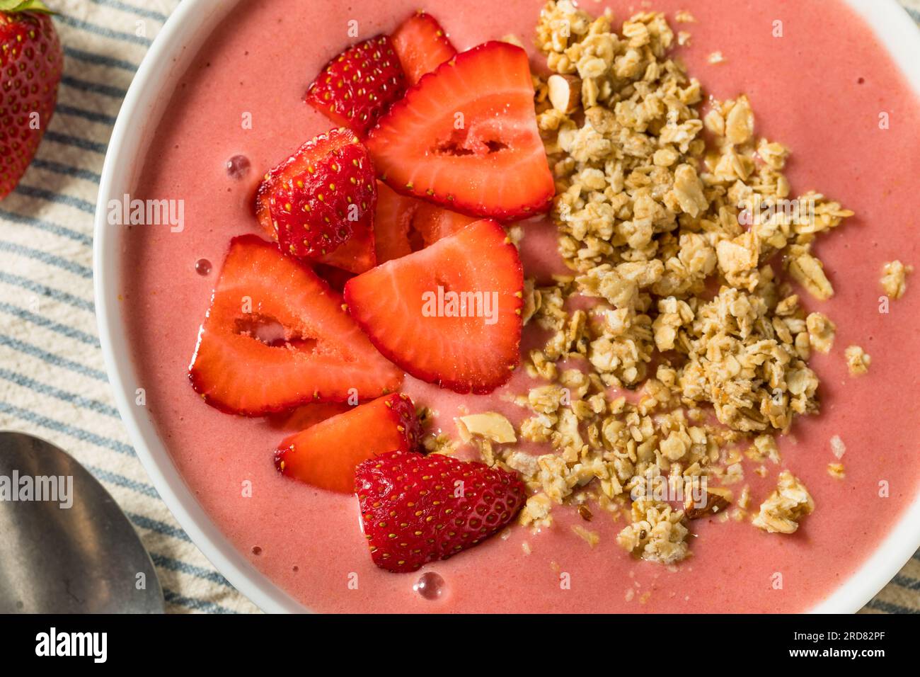 Homemade Strawberry Smoothie Bowl with Granola and Banana Stock Photo