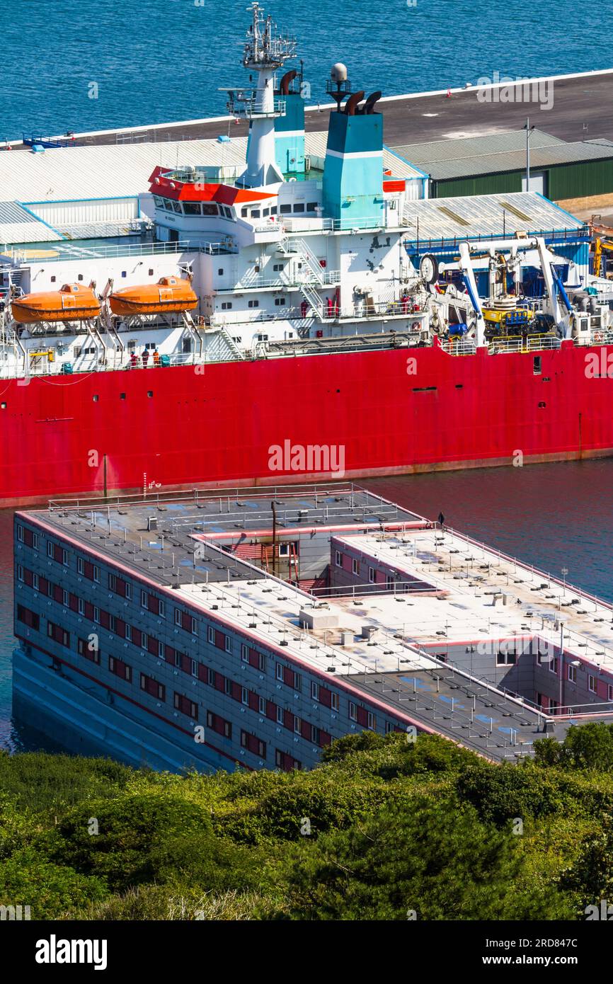 PORTLAND, ENGLAND – JUL 20  2023: Bibby Stockholm barge docked on land after arriving the day before. To house 500 UK asylum seekers. Portland, Weymou Stock Photo
