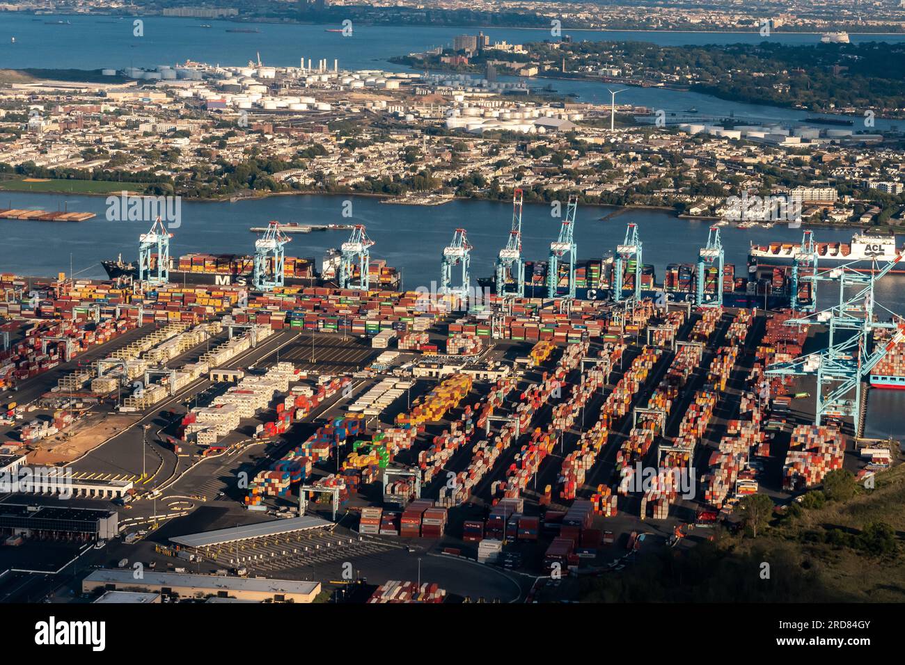 Aerial view of a freighter, cargo containers, Newark Bay, Panamax cranes, and the Port of Newark - Elizabeth Marine Terminal Stock Photo