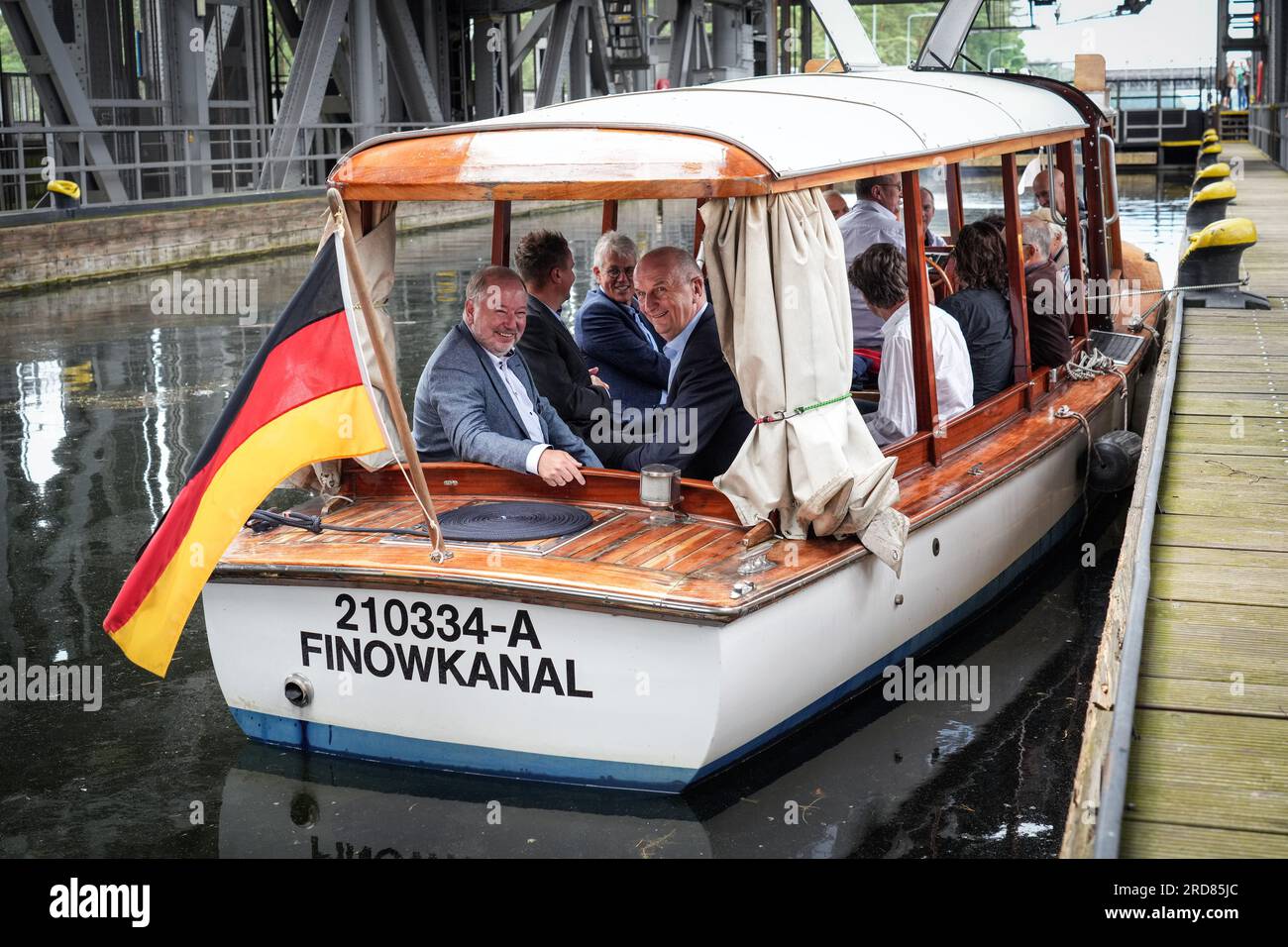 Niederfinow, Germany. 19th July, 2023. Dietmar Woidke (r, SPD), Minister President of Brandenburg, and Jan Mönikes (l), Managing Director of SHW Tourismus- und Wirtschaftsentwicklungsgesellschaft Niederfinow mbH, sit in the saloon boat 'Funtensee' during the traditional summer tour of the old ship lift in Niederfinow. The historic boat had been put into service in 2019 on the Königsee in Bavaria and brought to Niederfinow by the non-profit association 'Unser Finowkanal e.V.'. During the tourism press trip was visited the region Barnimer Land. Credit: Soeren Stache/dpa/Alamy Live News Stock Photo