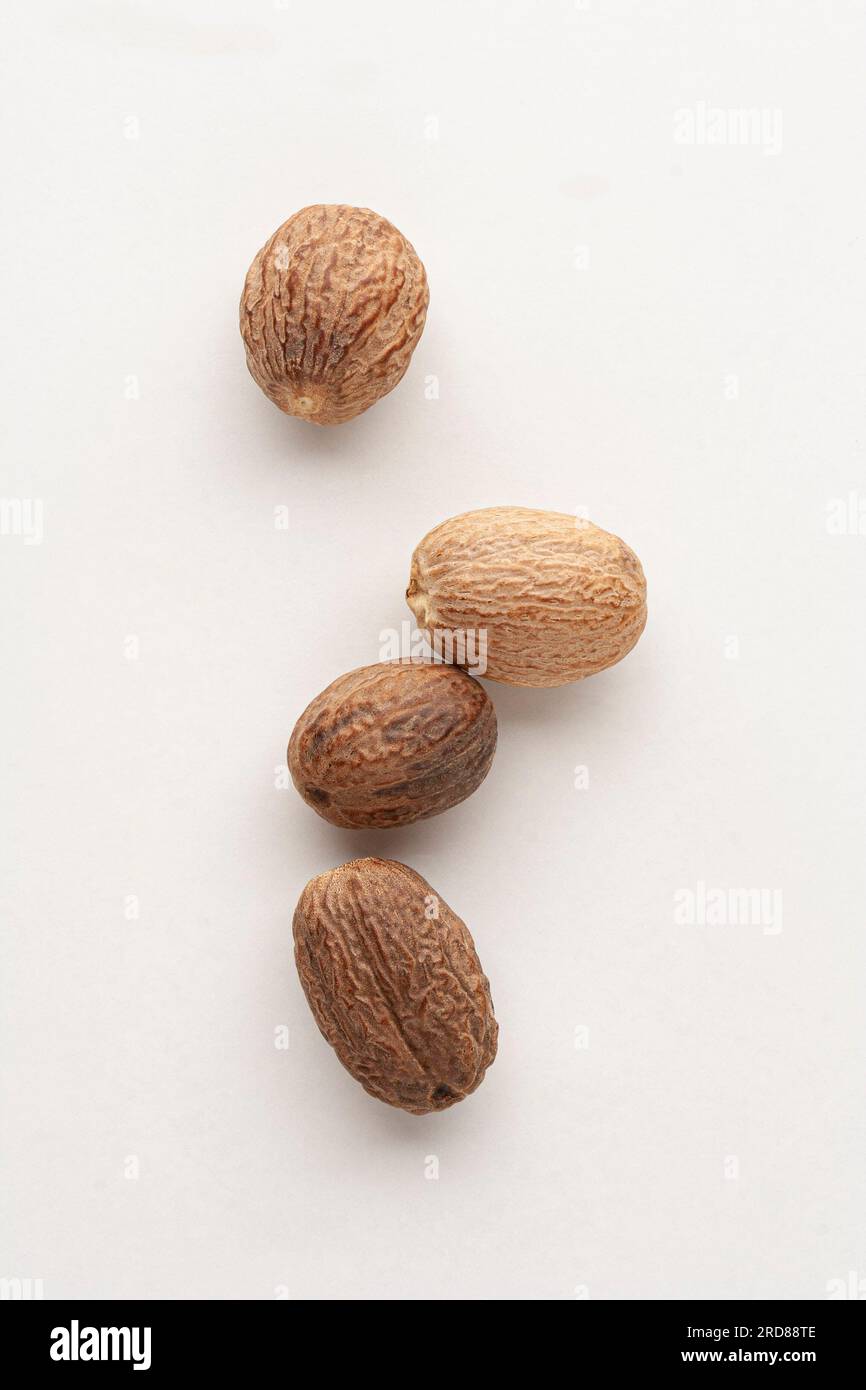 Group of whole nutmegs on white background Stock Photo