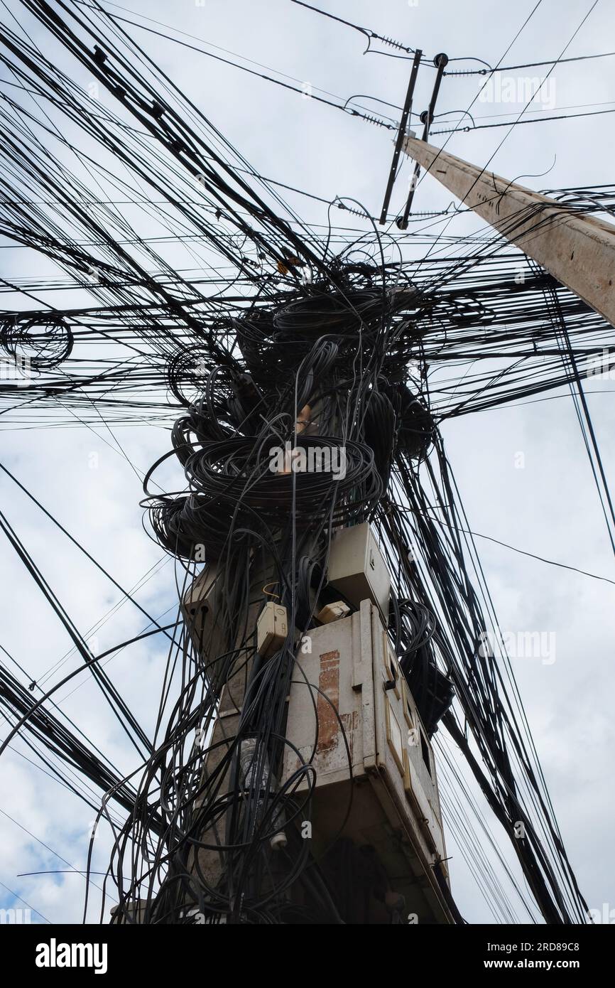 A photograph capturing a massive network of tangled electric cables