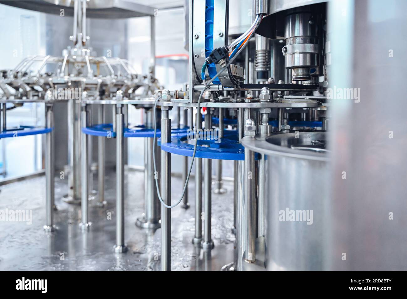 Water Bottle Process Control Bottling factory worker inspecting quality of water bottles before ...