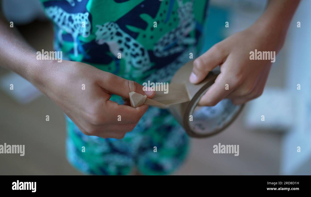 Child hand tearing duct tape roll Stock Photo Alamy