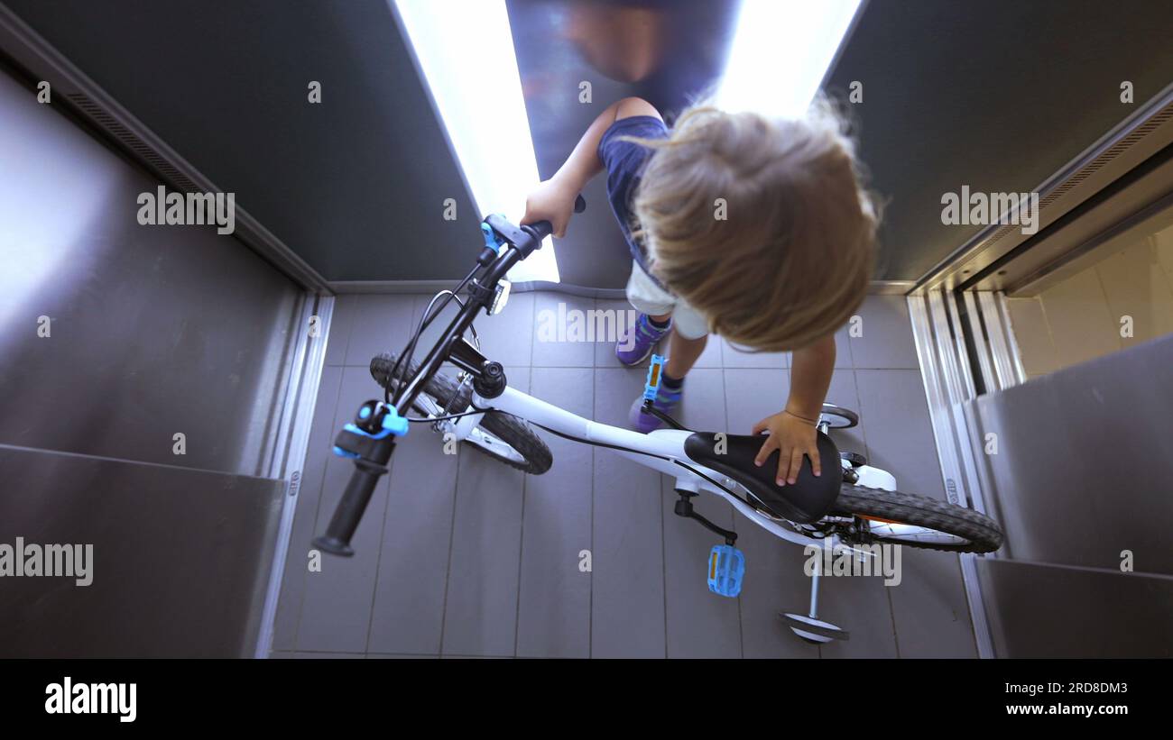 Child going out with bicycle leaving elevator kid leaves elevator Stock ...