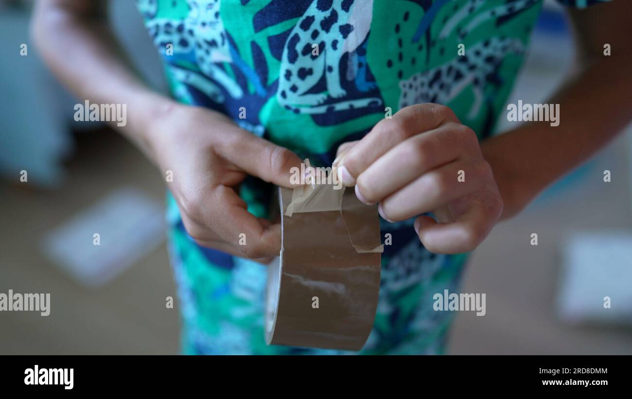 Child hand tearing duct tape roll Stock Photo Alamy