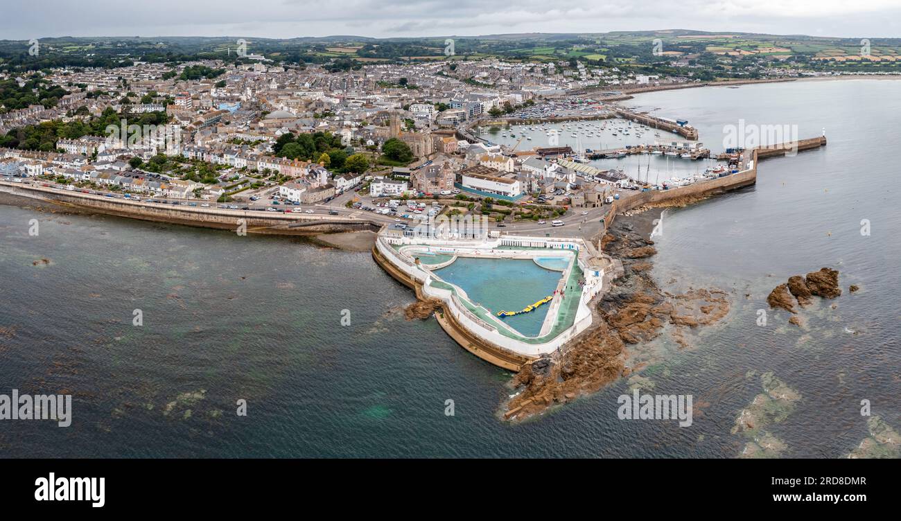 Aerial panorama landscape of the Cornish coast town of Penzance from the ocean with harbour and Jubilee swimming pool and copy space Stock Photo