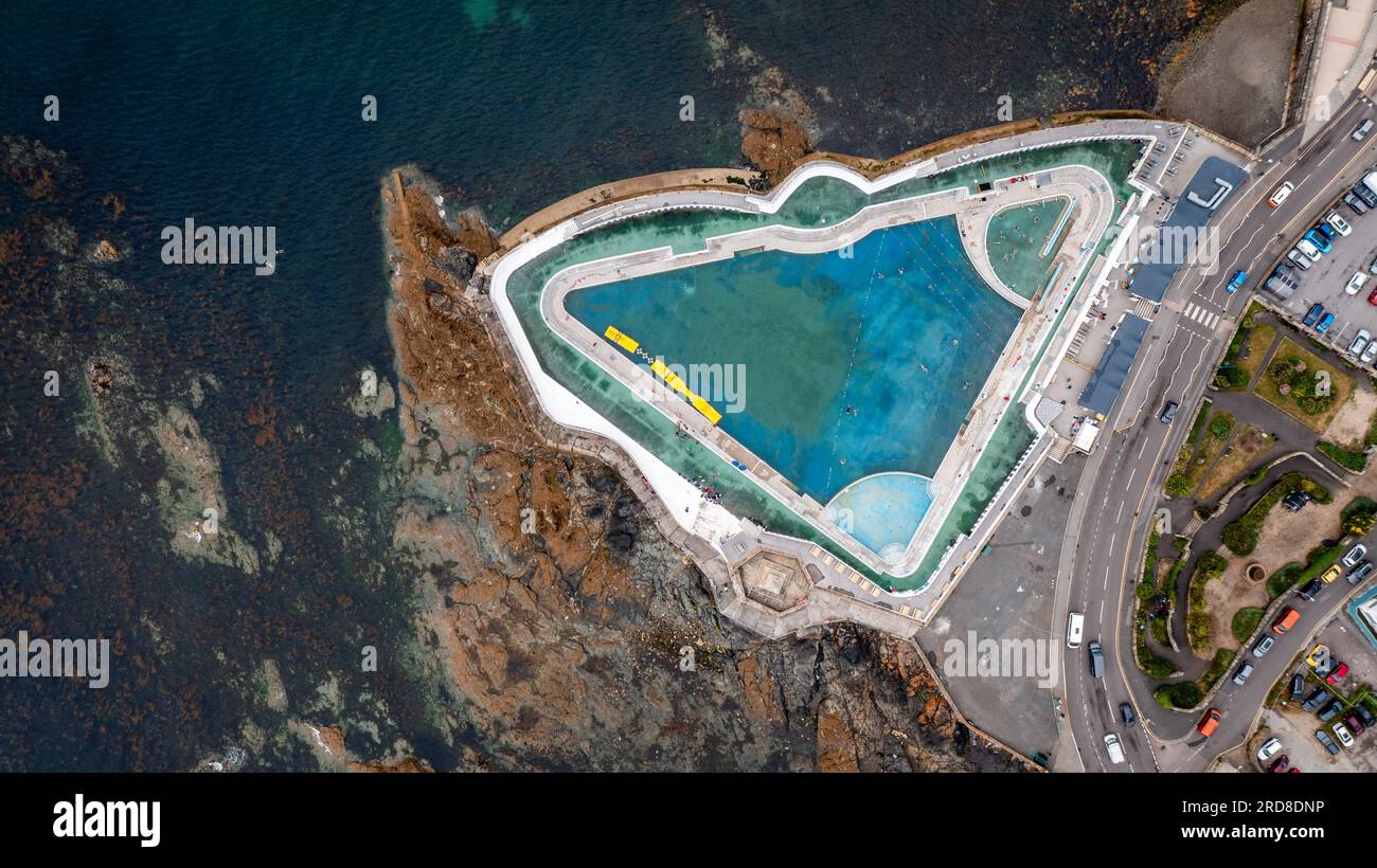Aerial view directly above The Jubilee outdoor swimming pool on the rocky coastline of Penzance in Cornwall Stock Photo