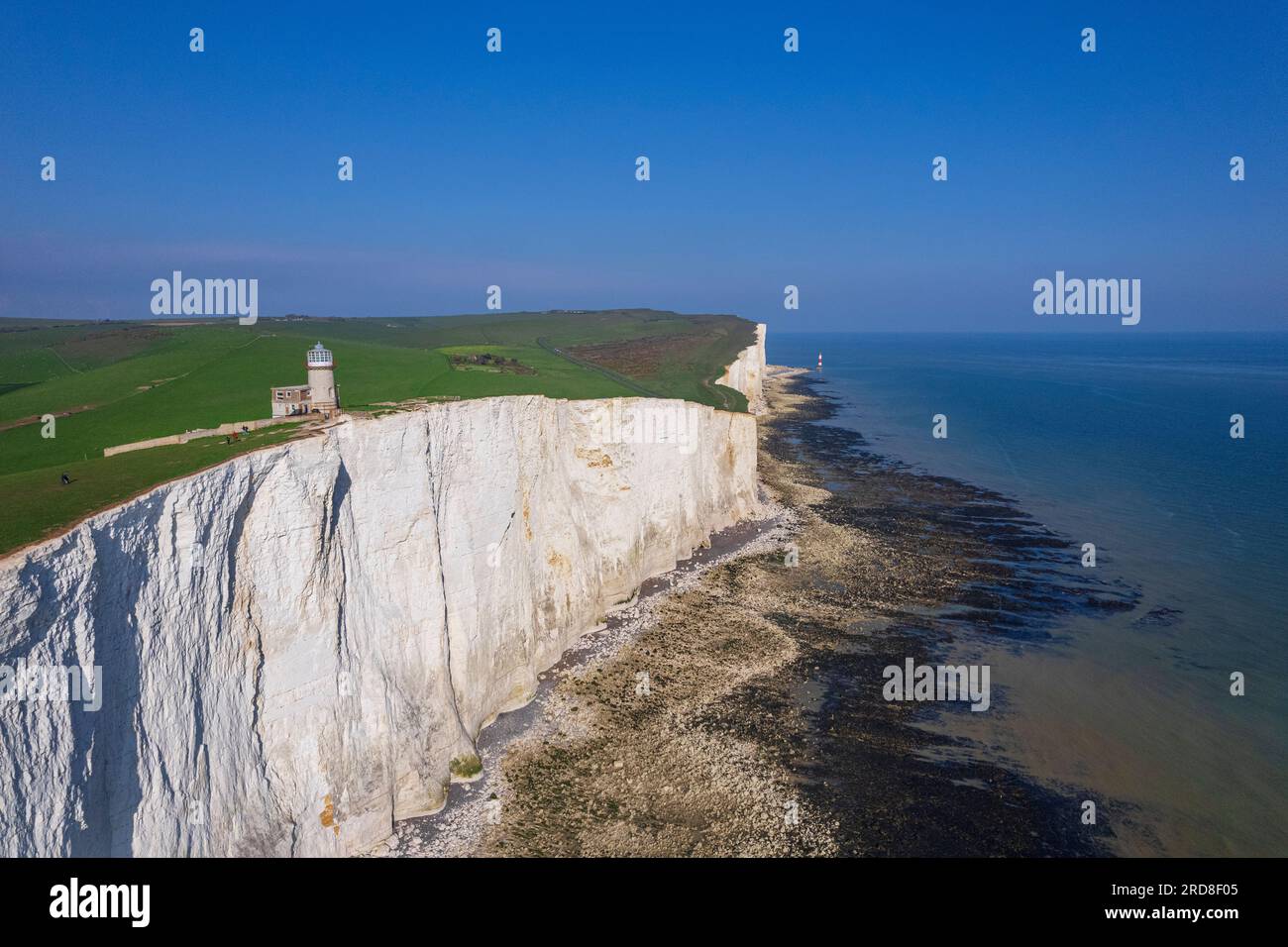 View from drone of Belle Tout lighthouse at low tide, Seven Sisters chalk cliffs, South Downs National Park, East Sussex, England Stock Photo