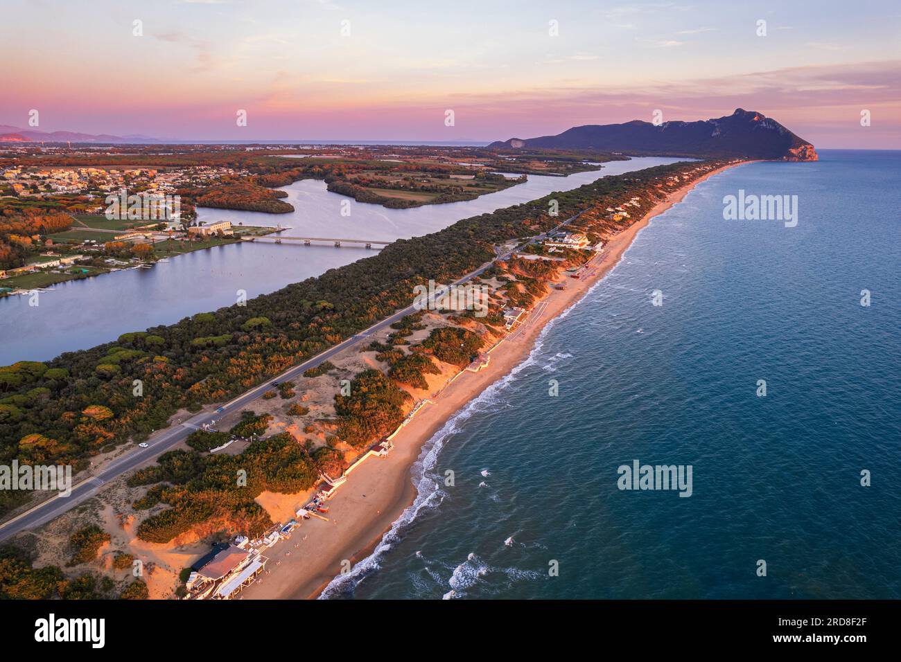 Aerial view of the lake and beach of Sabaudia with the woody mountain of Circeo in the background at dusk, Sabaudia, Tyrrhenian Sea Stock Photo