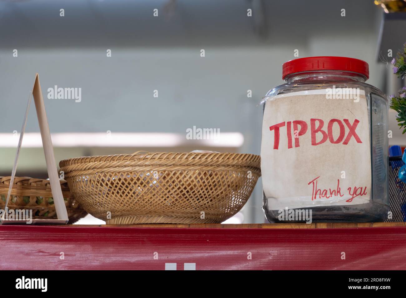 A bottle with a Tip box sign on the counter in the restaurant Stock Photo