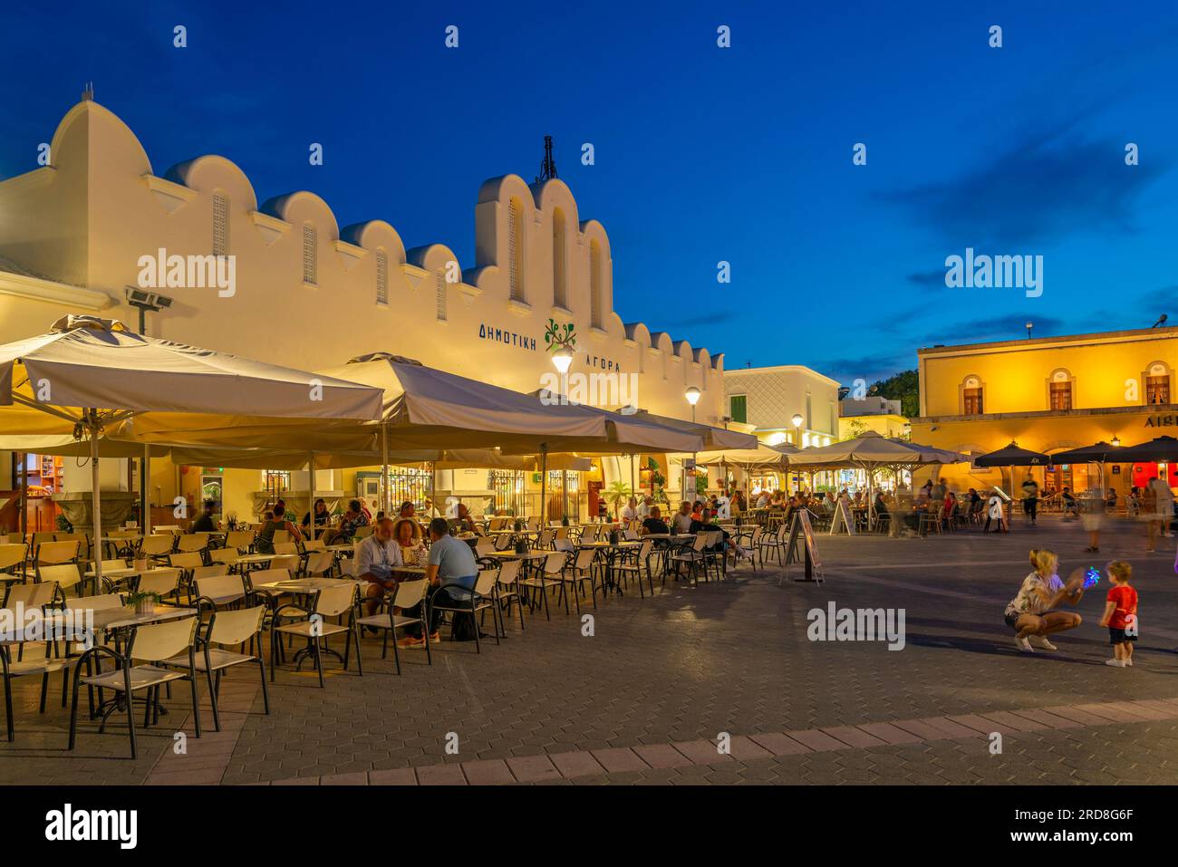 View of Kos Municipal Market in Eleftherias Central Square in Kos Town at dusk, Kos, Dodecanese, Greek Islands, Greece, Europe Stock Photo