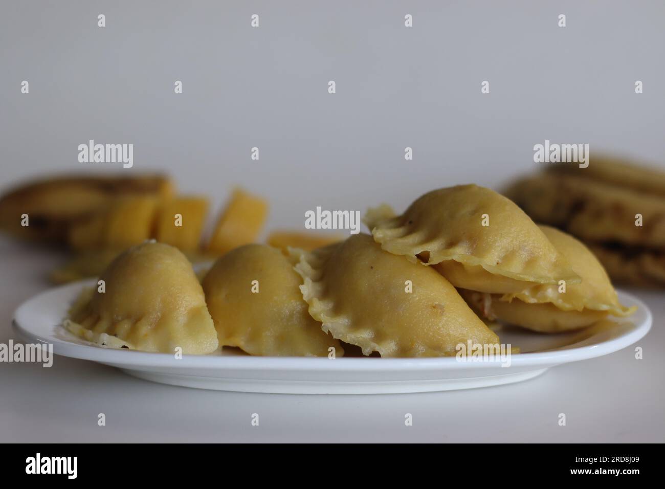 Plantain sweet dumplings or banana kozhukkatta. Steamed sweet dumplings made with a dough made of rice flour and mashed plantain and it has a filling Stock Photo