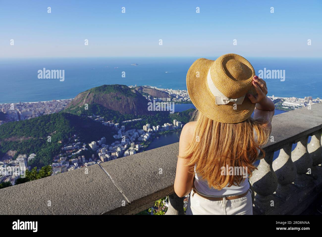 Tourism in Rio de Janeiro, Brazil. Traveler girl on Corcovado mountain looks cityscape of Rio de Janeiro, Brazil. Stock Photo