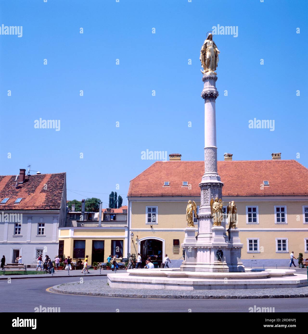 Golden statue with angels on the Kaptol square, Zagreb, Croatia.With clear blue sky. Stock Photo
