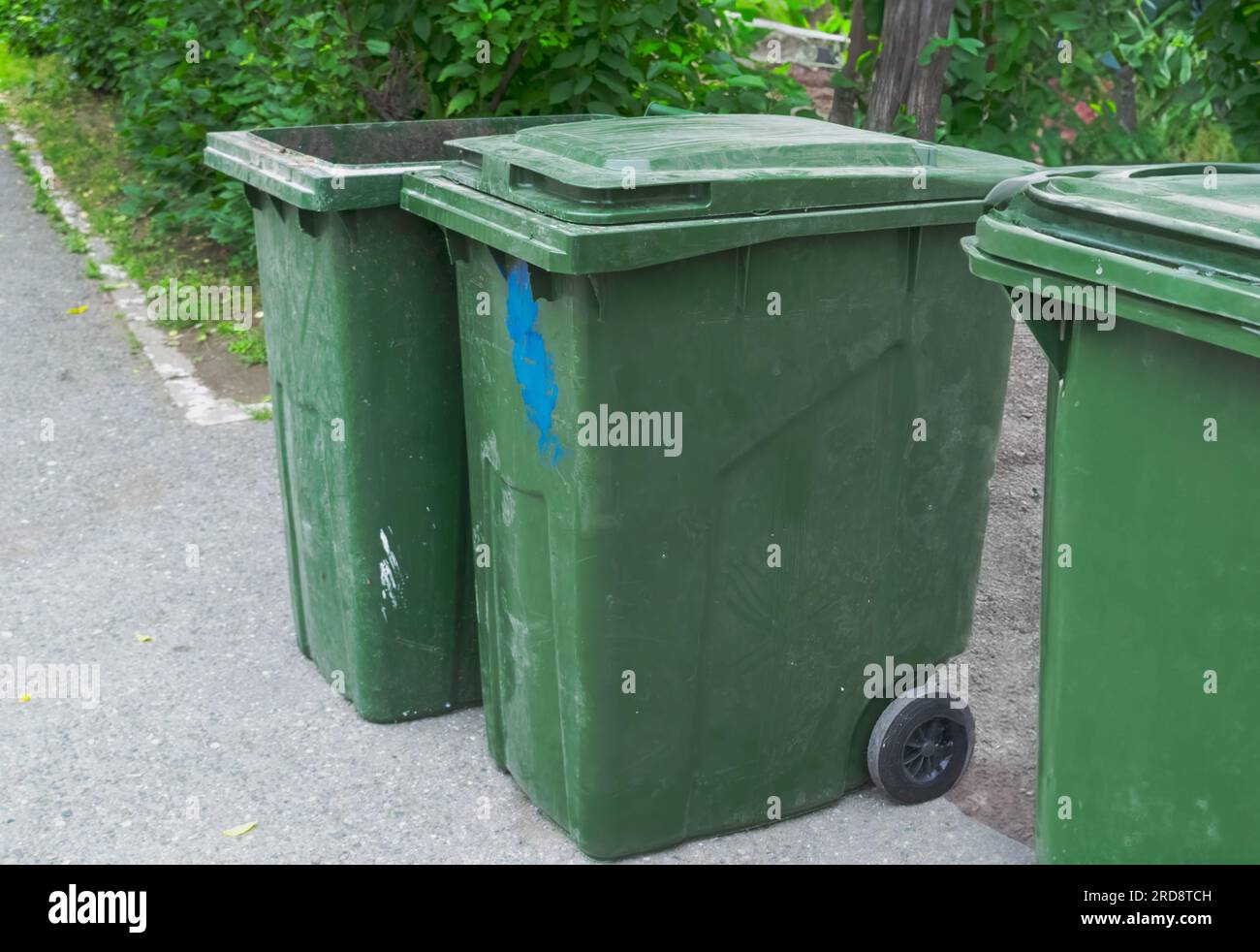 Three Green plastic trash recycling containers. Green containers for ...