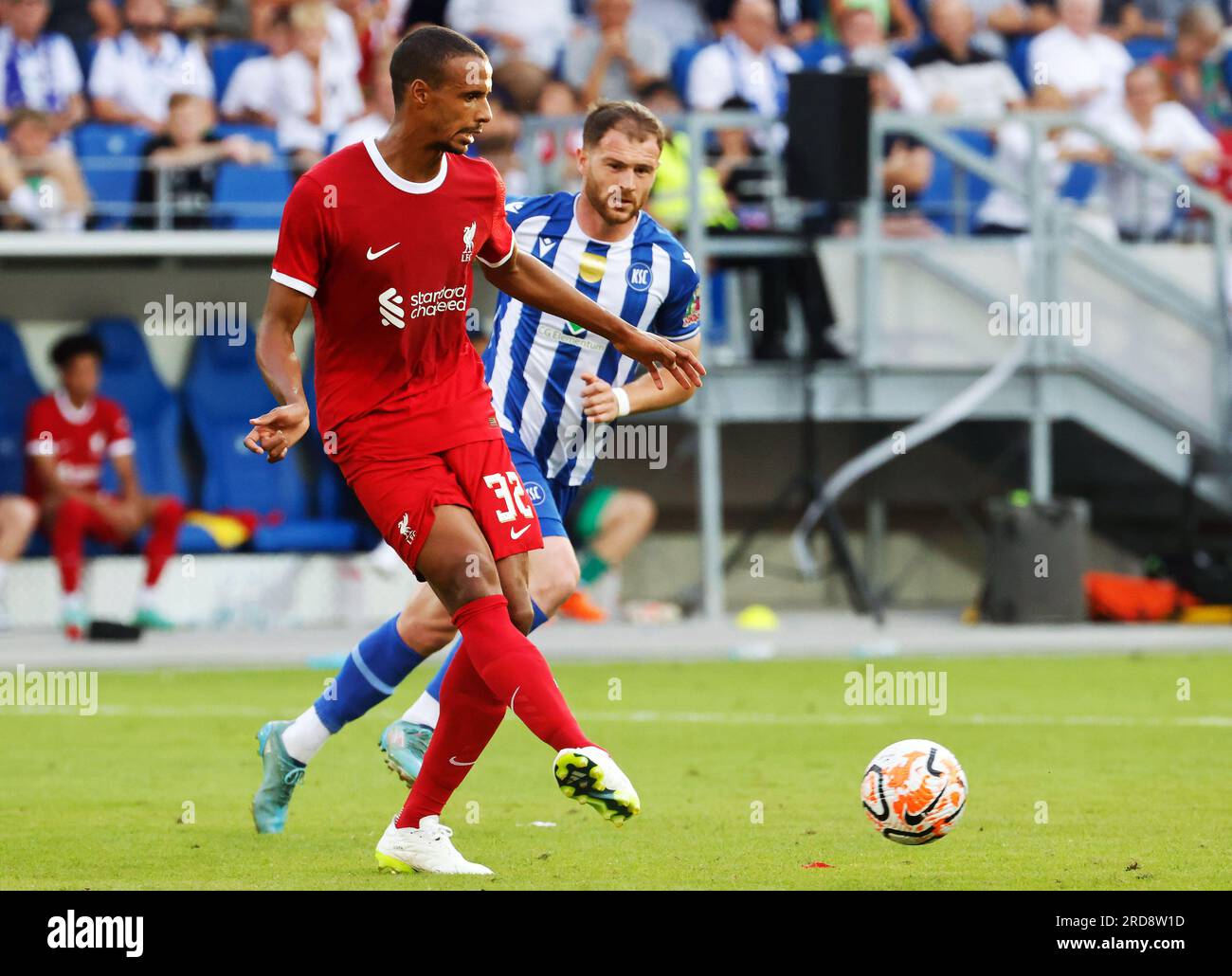 Karlsruhe, Germany. 19th July, 2023. Soccer: Test matches, Karlsruher SC - FC Liverpool: Liverpool's Joel Matip (front) and Karlsruhe's Budu Zivzivadze fight for the ball. Credit: Philipp von Ditfurth/dpa/Alamy Live News Stock Photo