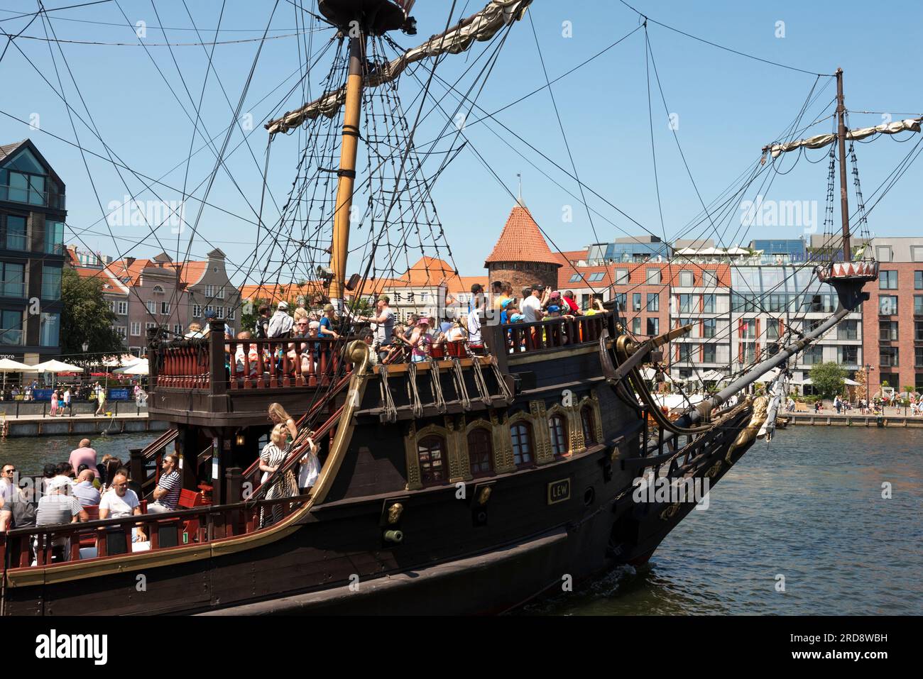 Tourists on board of the Lew pirate river cruise galleon ship on Motlawa River in the Old Town of Gdansk, Poland Stock Photo