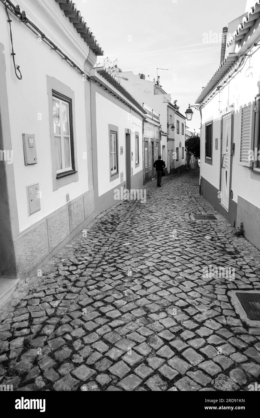 Ferragudo, Portugal- October 20, 2022: Narrow Cobblestone streets and typical Portuguese facades in Ferragudo town, Portugal Stock Photo
