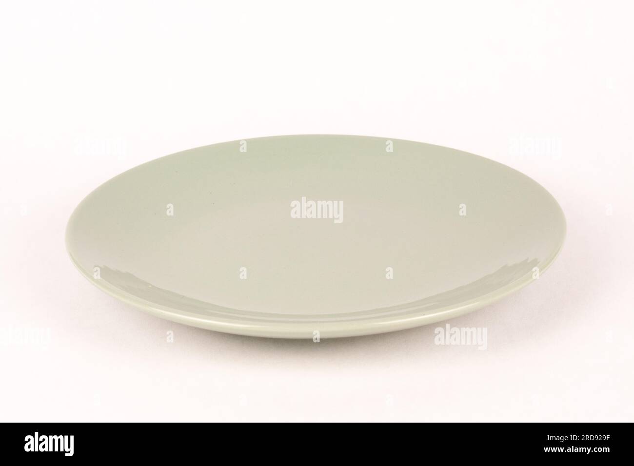 Empty gray green glass plate white background Stock Photo