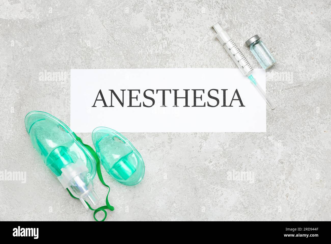 Paper with word ANESTHESIA, oxygen masks, syringe and ampule on grunge