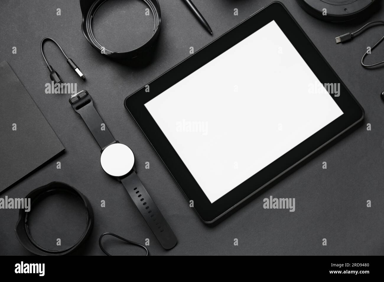 Set of modern gadgets with tablet computer on dark background Stock Photo