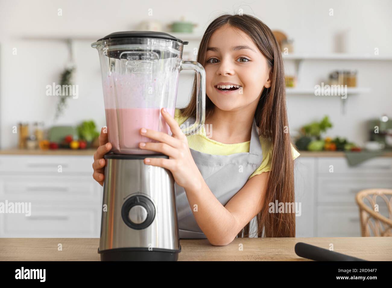 Little girl making smoothie with blender in kitchen Stock Photo Alamy