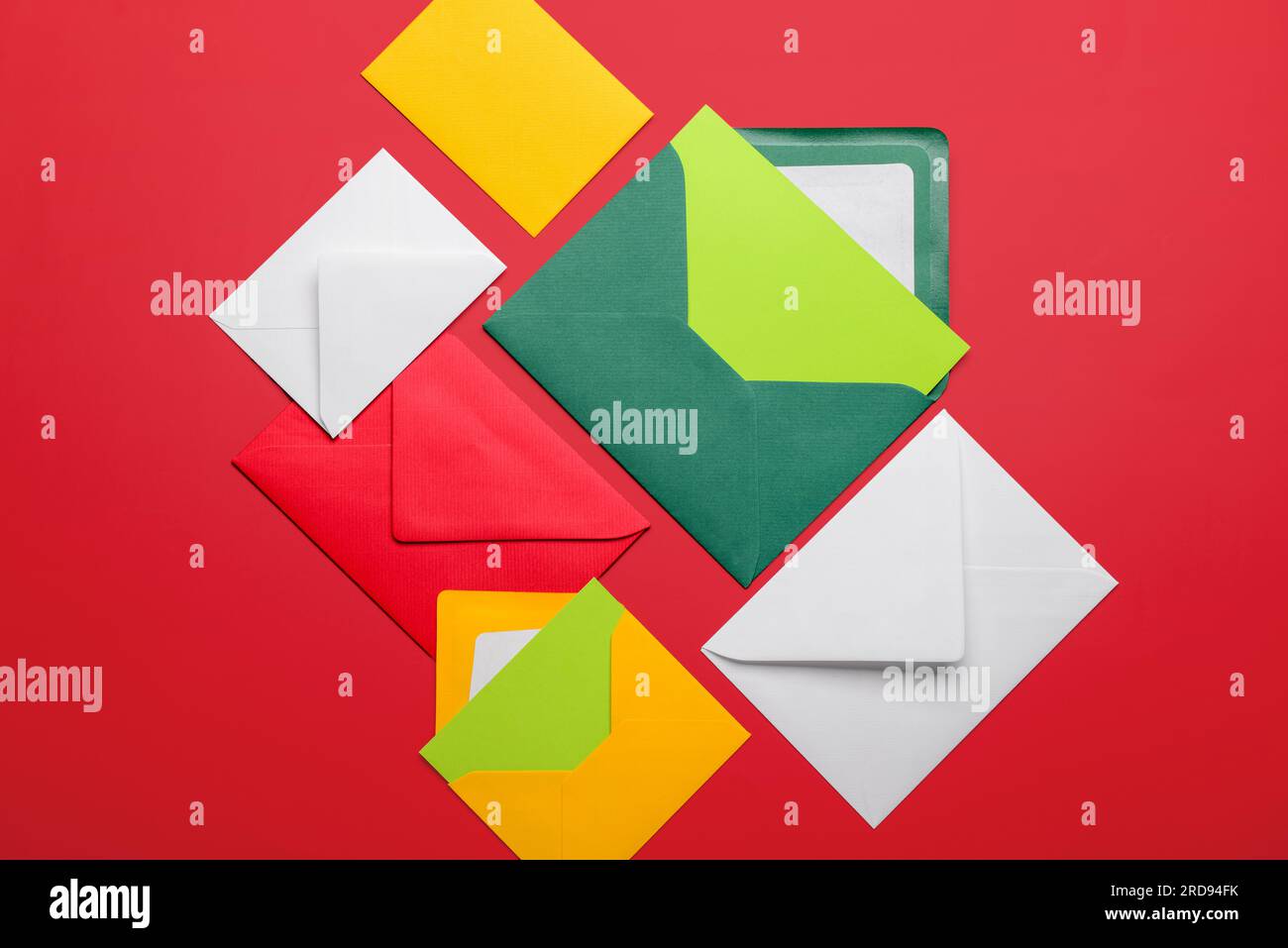 Composition with different envelopes and blank cards on red background Stock Photo