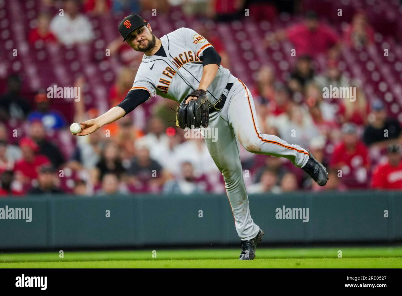 San Francisco Giants' J.D. Davis fields the ball and throws to first base  during a baseball game against the Cincinnati Reds in Cincinnati, Tuesday,  July 18, 2023. (AP Photo/Aaron Doster Stock Photo 