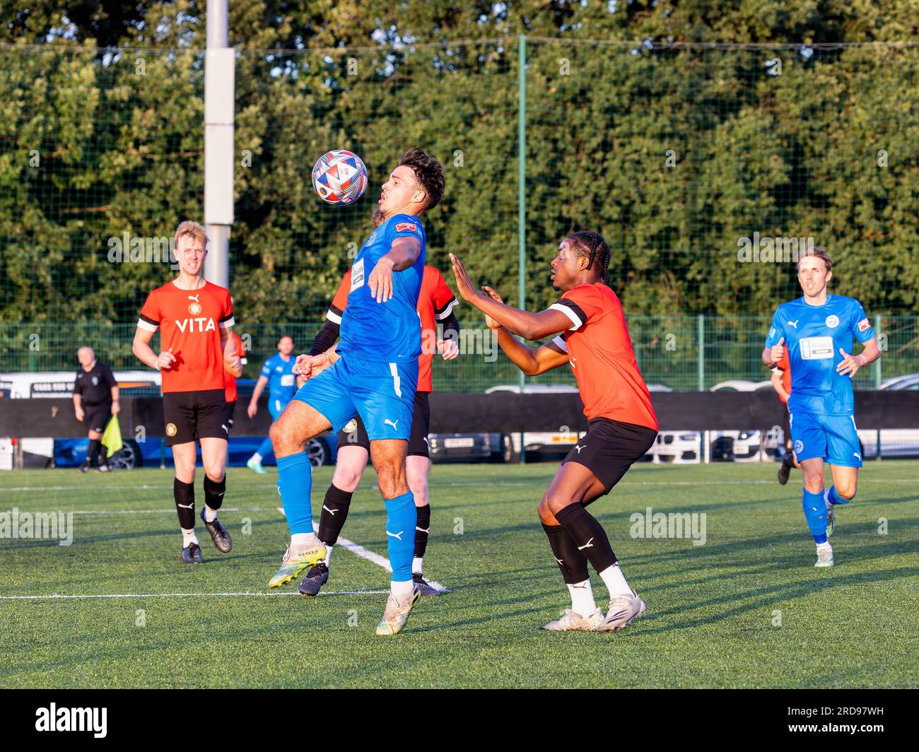Warrington Rylands Scott Bakkor keeps his eye on a high ball in front of a  Stockport Town defender at Stockport Sports Village on a 3G pitch Stock  Photo - Alamy