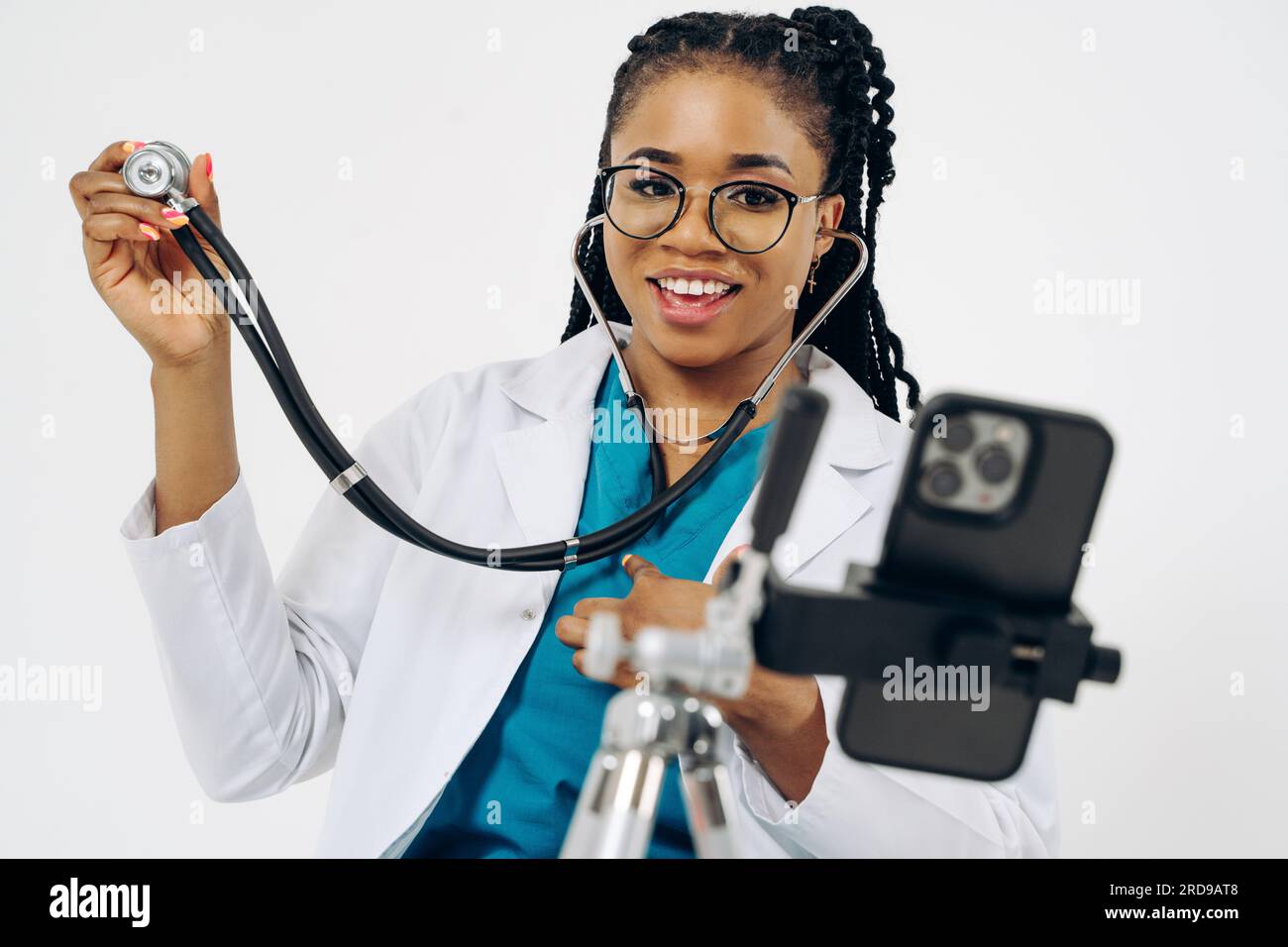 Happy african american doctor woman wears medical coat holding and