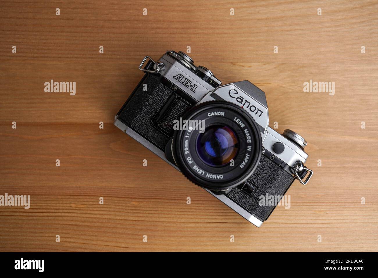 Canon AE1 SLR film camera with accessories (film roll and cable