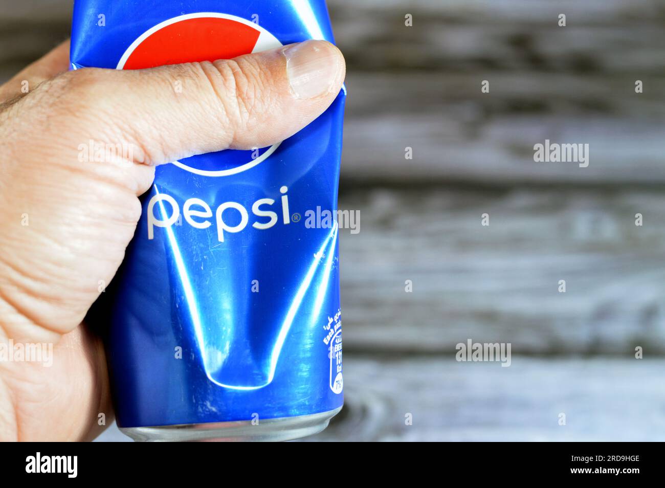 Cairo, Egypt, June 24 2023: Crushed Pepsi can, Cola flavor plastic bottle, a carbonated soft drink manufactured by PepsiCo. Originally created and dev Stock Photo