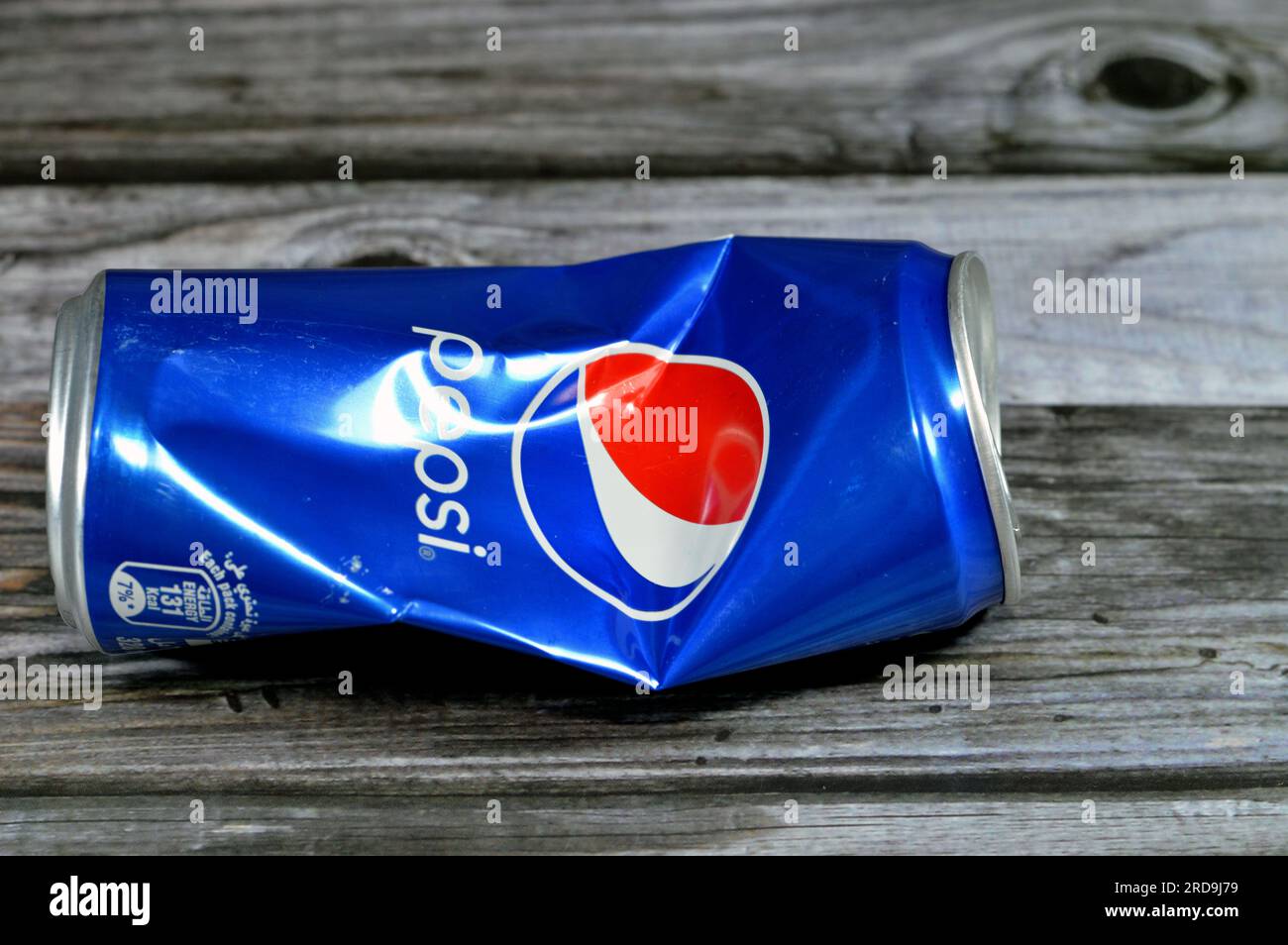 Cairo, Egypt, June 24 2023: Crushed Pepsi can, Cola flavor plastic bottle, a carbonated soft drink manufactured by PepsiCo. Originally created and dev Stock Photo