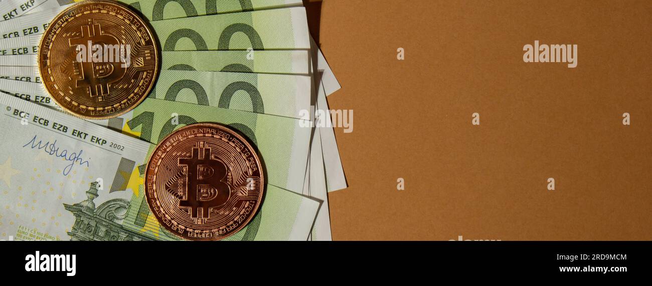 Bitcoin gold coin on bills of 100 euros eu currency. Bitcoin mining trading concept. BTC golden money. Worldwide virtual internet Cryptocurrency or crypto digital payment system. Digital coin money farm in digital cyberspace Stock Photo
