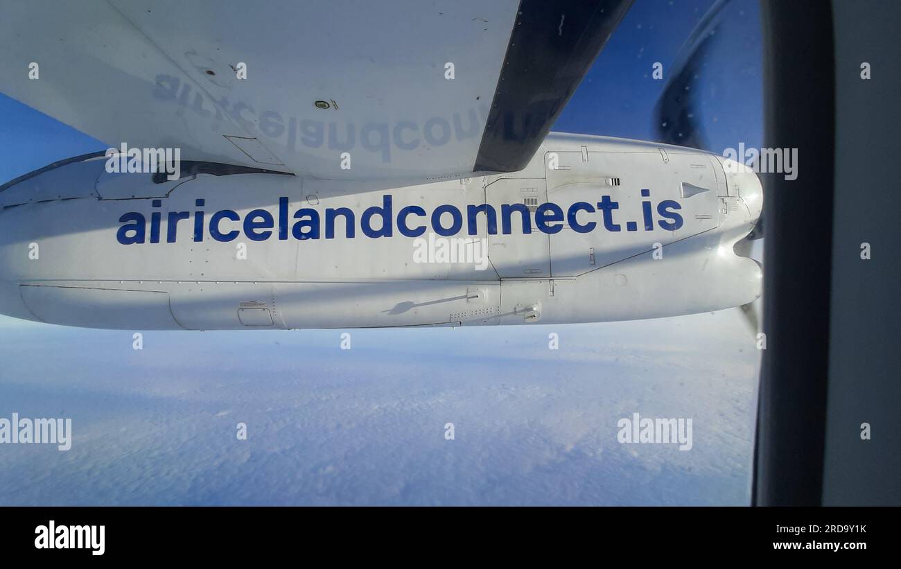 Nuuk, Greenland - Julne 2, 2023: propeller of air iceland aircraft with internet address in detail while flying. Stock Photo