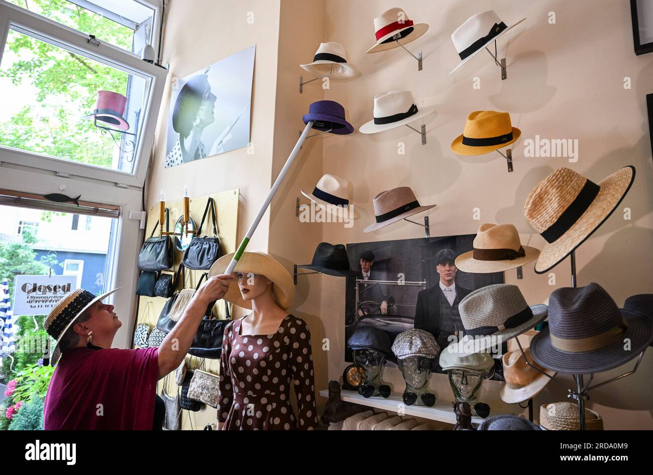 Berlin, Germany. 19th July, 2023. In her studio in the Günzelkiez in  Wilmersdorf, milliner Petra Benz arranges Panama and summer hats, which  offer additional UV protection thanks to a coating. In summer,