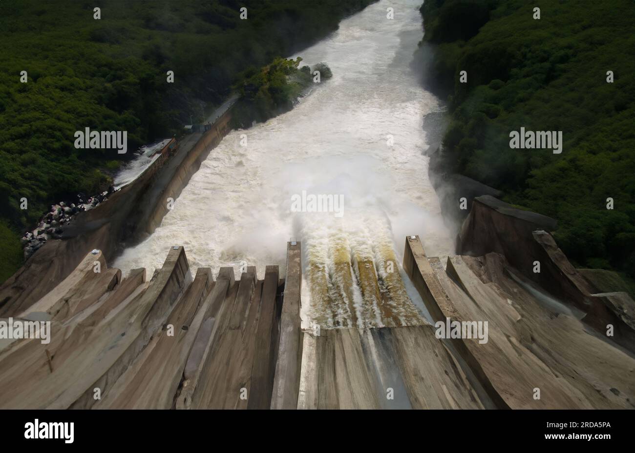 Water cascading over an old dam in nature. Stock Photo