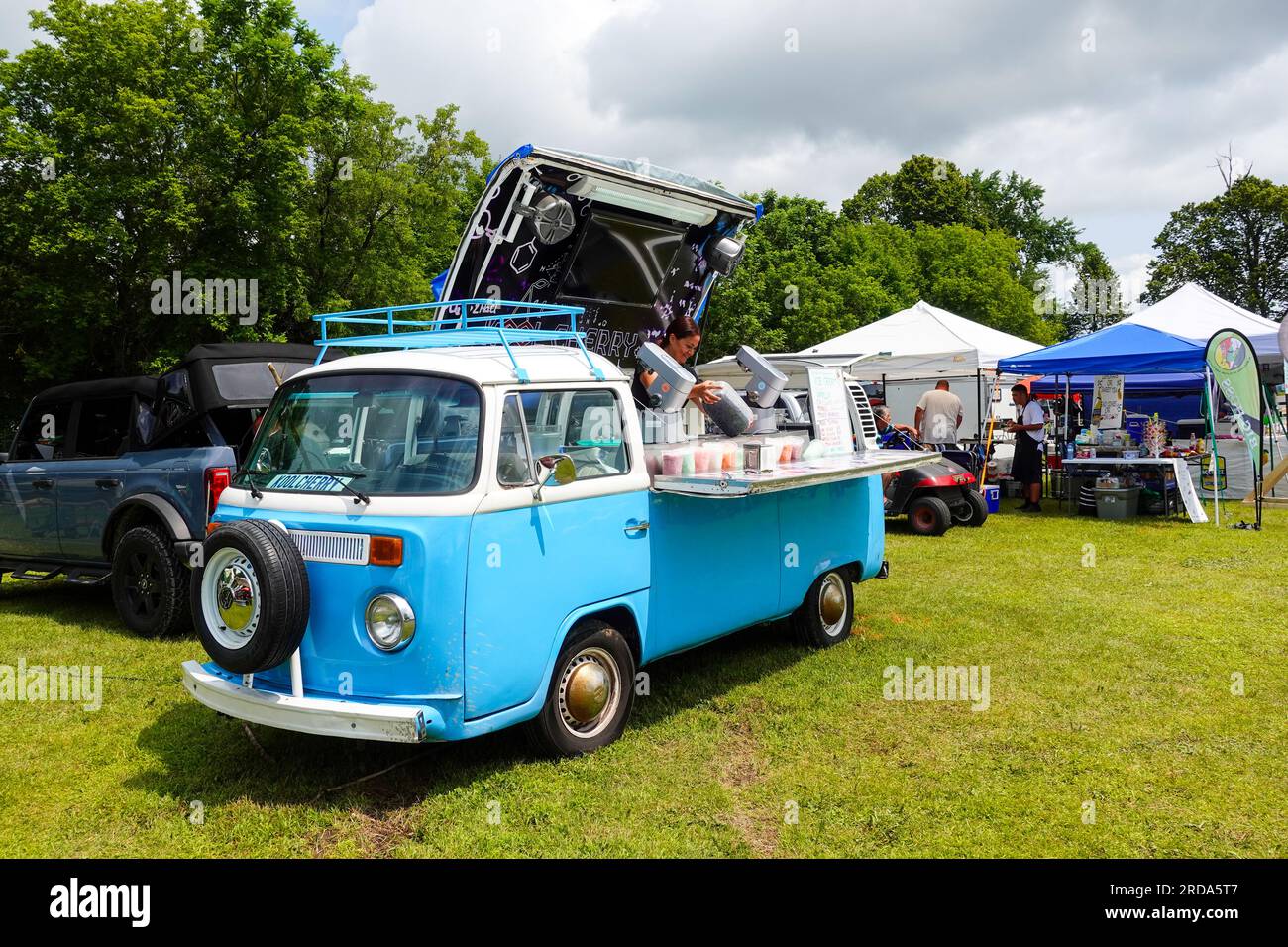 blue vw camper converted to a mobile ice cream vending food truck Stock Photo