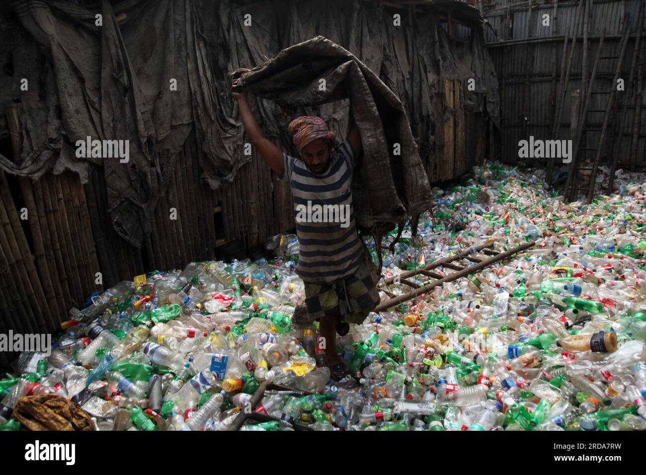 Dhaka, Dhaka, Bangladesh. 18th March, 2023. A man are working at a plastic bottle recycling factory. photo was taken kmarangichar beribadgh. Nazmul is Stock Photo