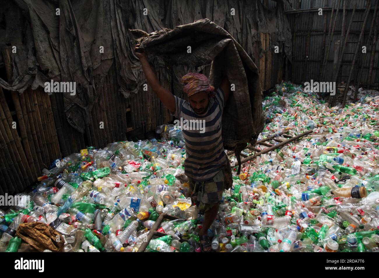 Dhaka, Dhaka, Bangladesh. 18th March, 2023. A man are working at a plastic bottle recycling factory. photo was taken kmarangichar beribadgh. Nazmul is Stock Photo