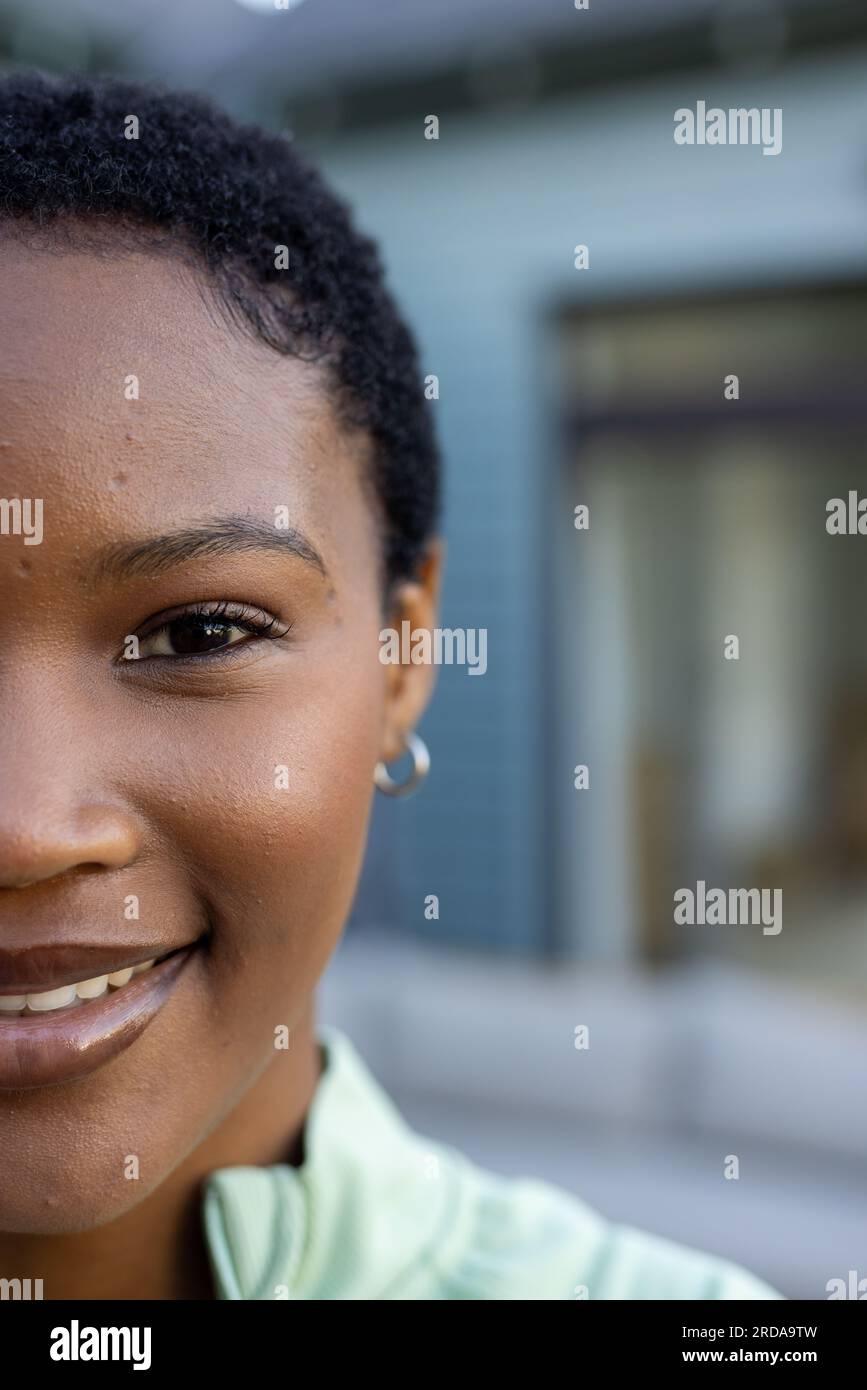 Portrait of happy african american woman with short black hair, smiling, copy space Stock Photo
