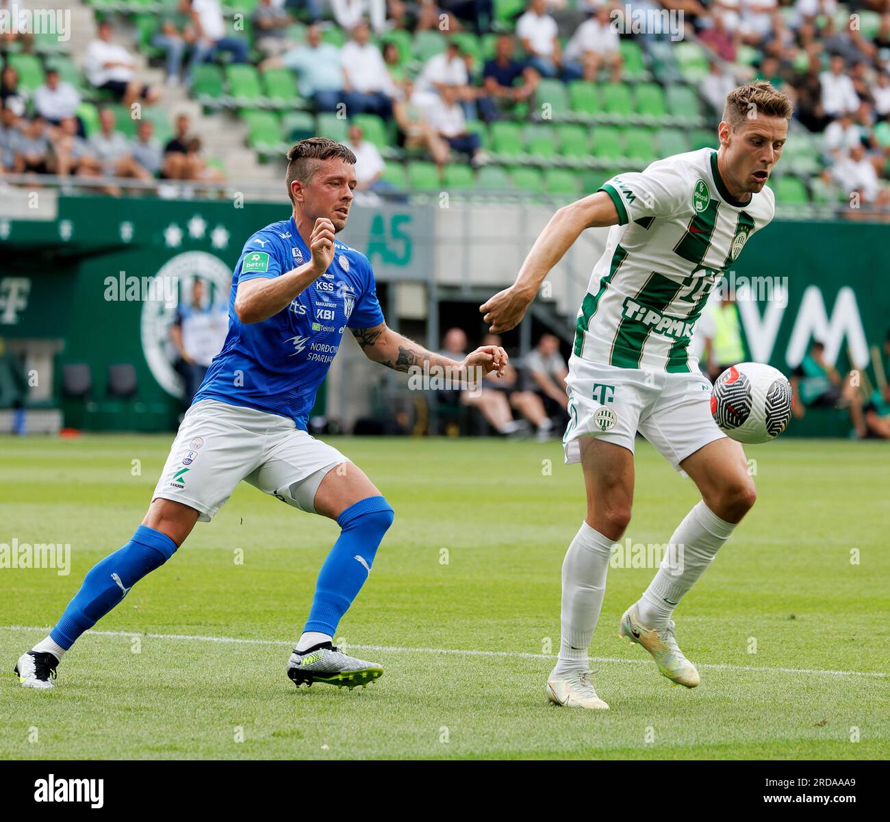 BUDAPEST, HUNGARY - JULY 13: Aleksa Amanovic of FC Tobol challenges  Kristoffer Zachariassen of Ferencvarosi TC during the UEFA Champions League  2022/23 First Qualifying Round Second Leg match between Ferencvarosi TC and