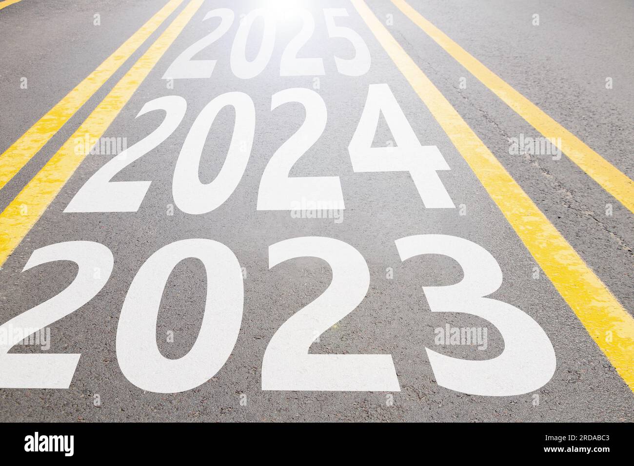 2023 and 2024 and 2025 written on the asphalt road going forward in Ukraine, the beginning of the new year and the way forward, freedom Stock Photo