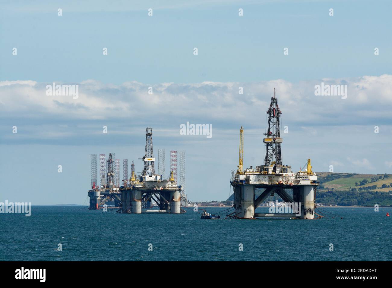 Oil Rigs waiting in Cromarty Firth off Invergordon. Calm seas and blue skies. Stock Photo