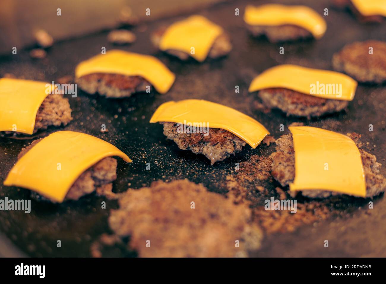 Ground Beef with Cheese for Hamburger on Flat Top Grill Outdoors Stock