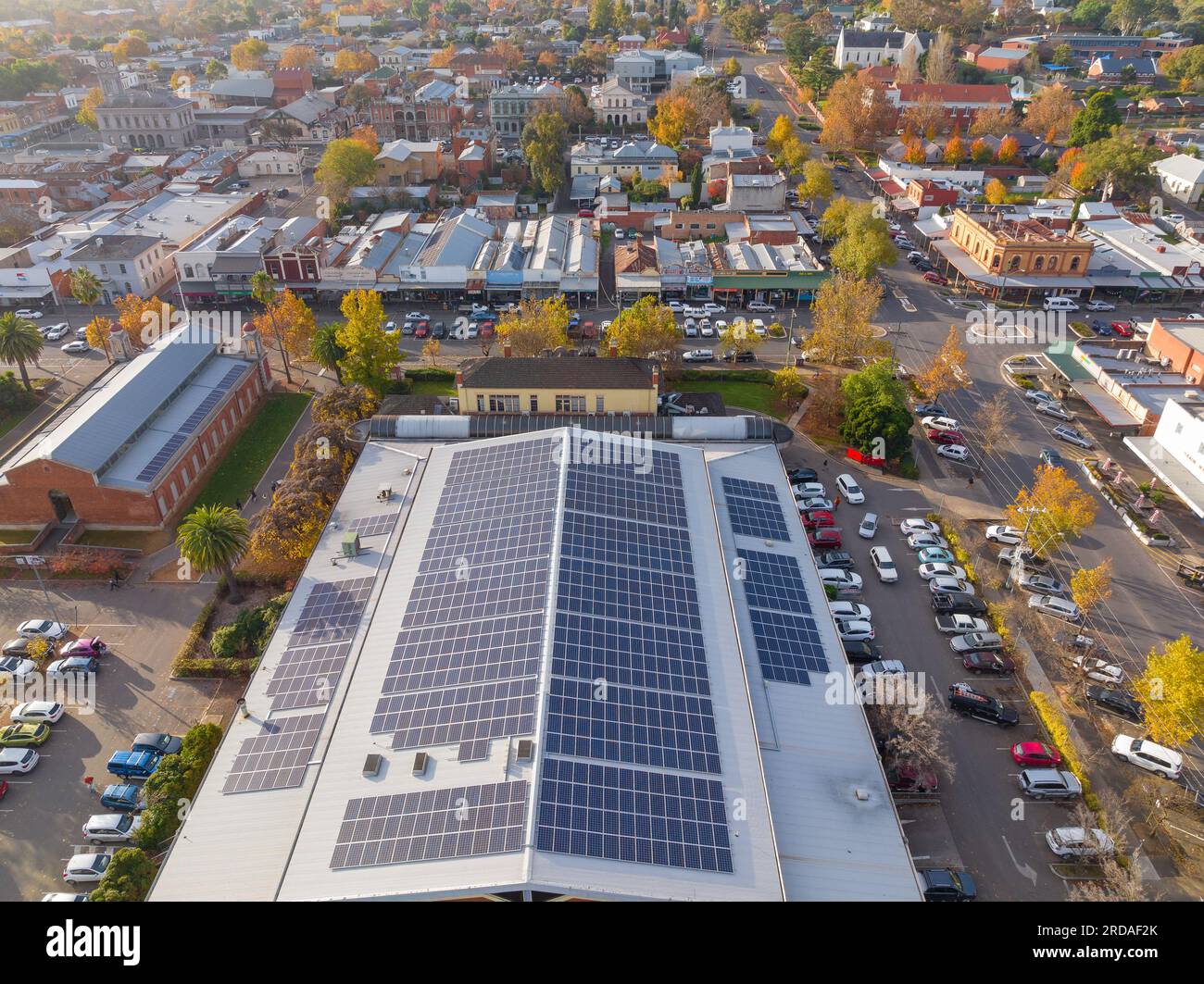 Aerial view of a large roof covered in solar panels surrounded by