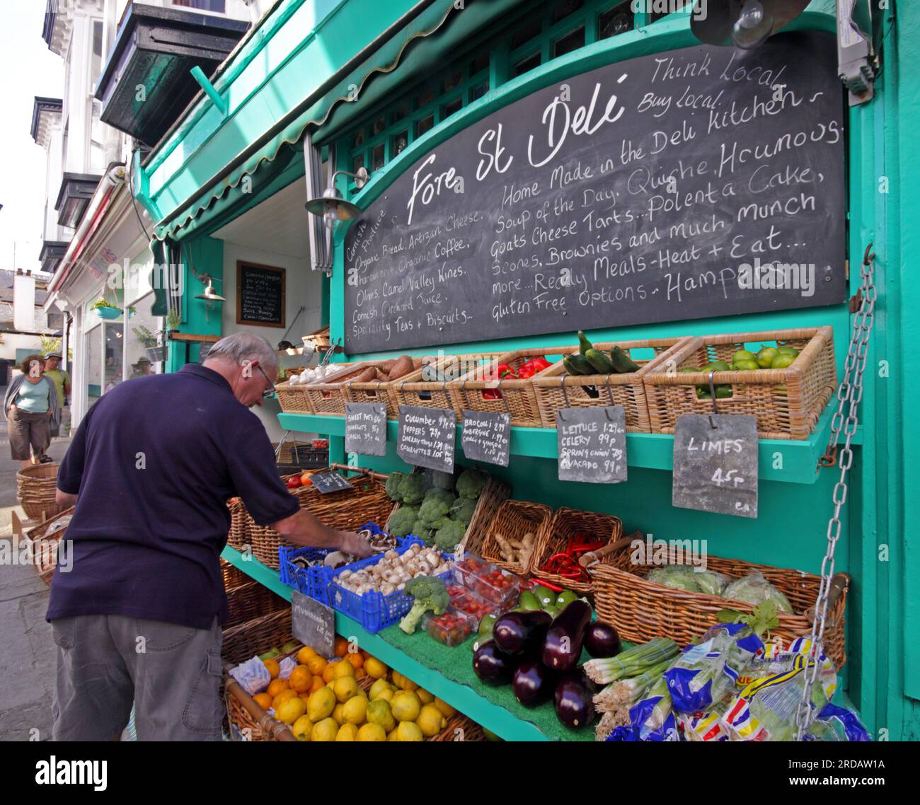 St Ives village local shops, the Fore Street Deli, fruit, vegetables, ready meals, hampers etc listed on blackboard, 30A Fore St, St Ives, Cornwall Stock Photo
