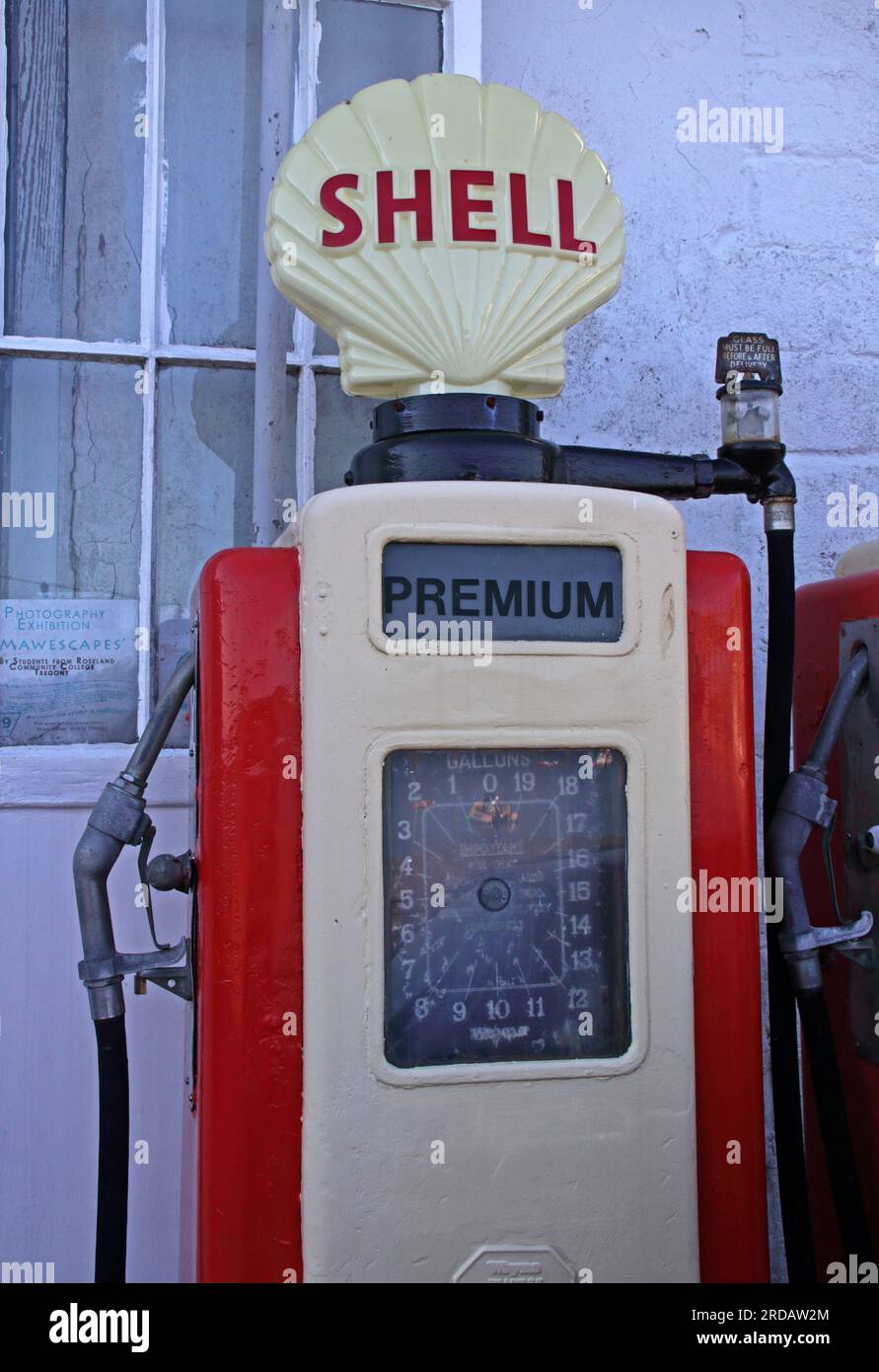 Antique vintage Shell petrol pumps, painted red on the harbourfront, St Mawes, Cornwall, England, UK, TR2 5AG Stock Photo